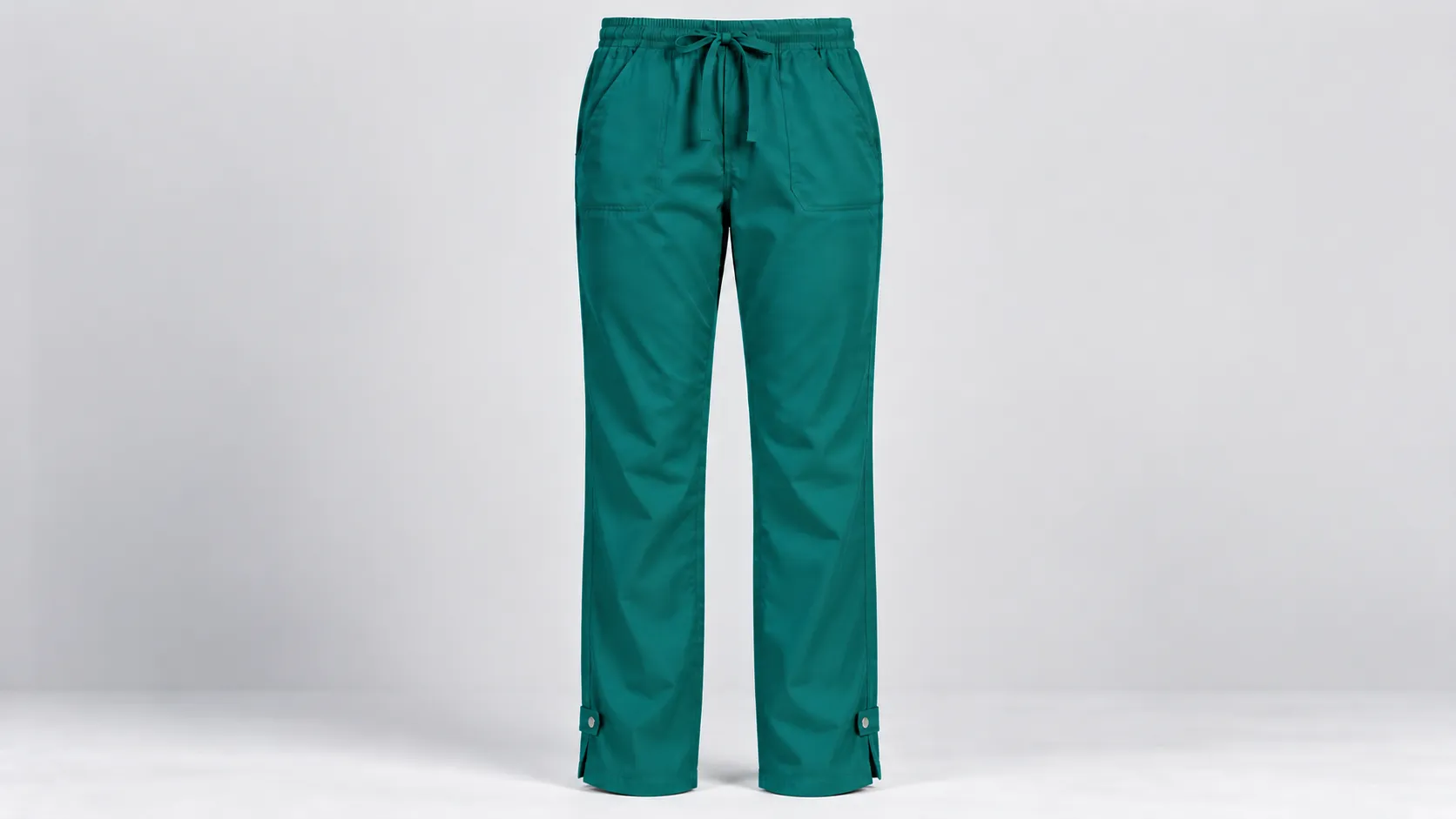 Teal scrub pants with button-tab adjustable leg openings, drawstring waist and front patch pockets.