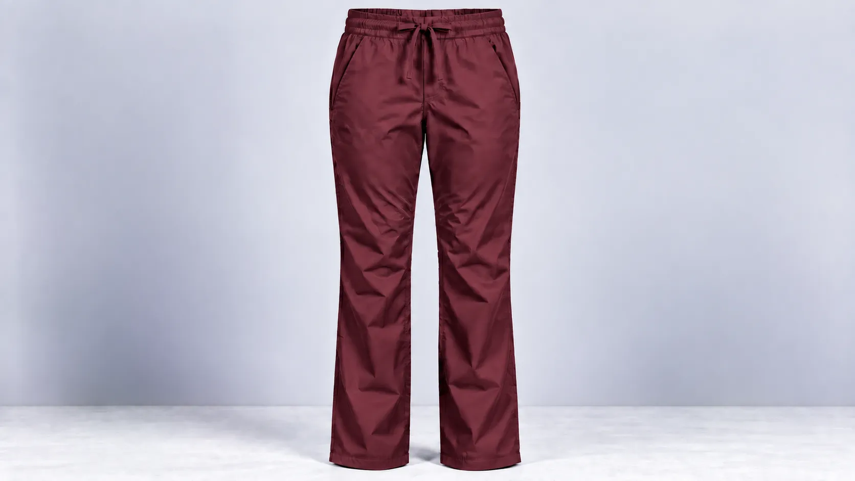 Burgundy scrub pants featuring straight legs, a drawstring elastic waist and two side pockets.