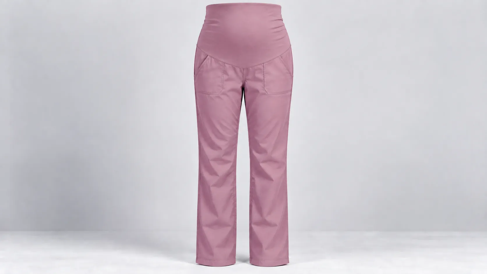 Pink scrub pants featuring a full maternity belly panel with two front pockets and a straight-leg fit.