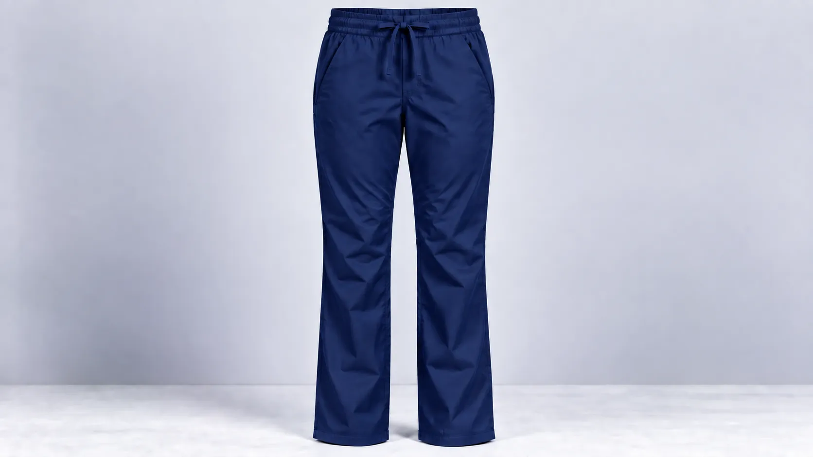 Navy scrub pants featuring straight legs, an adjustable drawstring waist and two side pockets.