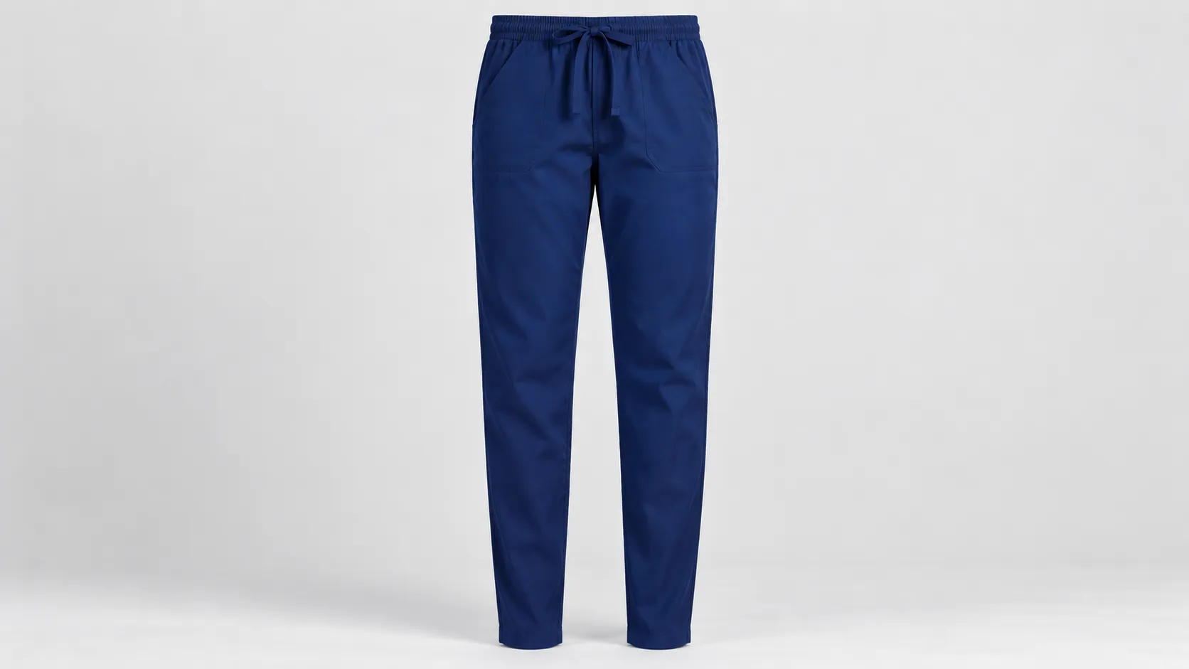 Navy scrub pants featuring tapered legs, an adjustable drawstring waist and practical front pockets.